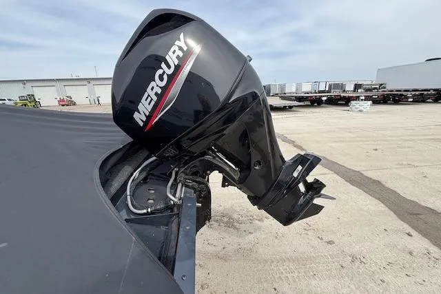 Slide: The Image of 2024 Lund 1650 Rebel XL Sport with Mercury outboard motor in a parking lot. - 5