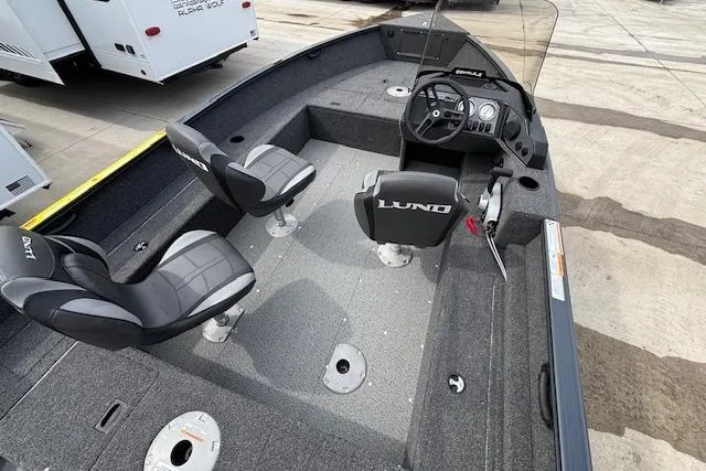 Slide: The Image of 2024 Lund 1650 Rebel XL Sport boat interior with seating and steering console. - 7