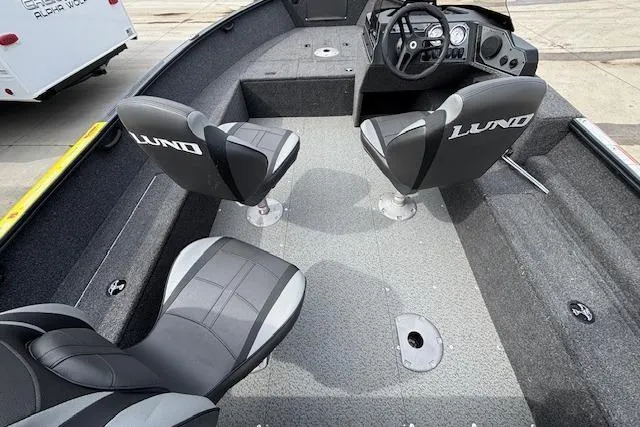 Slide: The Image of 2024 Lund 1650 Rebel XL Sport boat interior with two seats and steering console. - 8