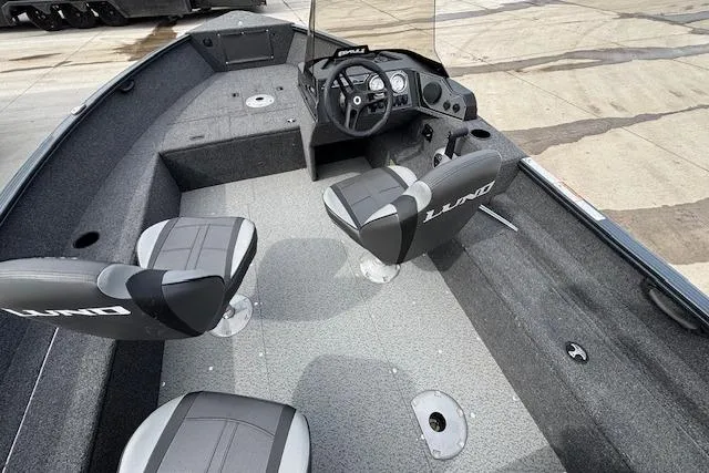 Slide: The Image of 2024 Lund 1650 Rebel XL Sport boat interior with two seats and steering console. - 9