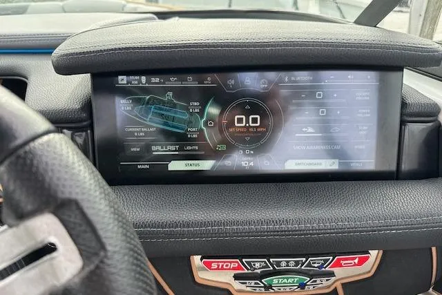 Slide: The Image of Dashboard of 2018 Nautique Super Air Nautique GS22 boat with digital display and controls. - 2