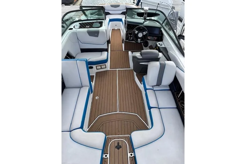 Slide: The Image of 2018 Nautique Super Air Nautique GS22 interior with sleek seating and wooden flooring. - 3