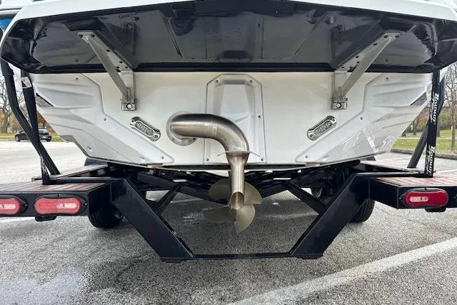Slide: The Image of 2018 Nautique Super Air Nautique GS22 boat on trailer, rear view showing propeller and exhaust. - 7