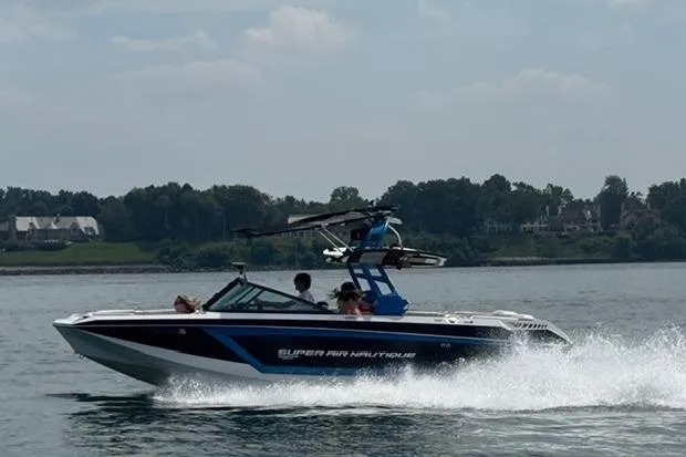 Slide: The Image of 2018 Nautique Super Air Nautique GS22 speeding on a lake with passengers onboard. - 8