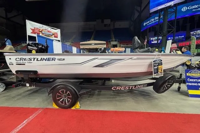 The Image of 2026 Crestliner 1850 Pro Tiller boat displayed at an indoor exhibition. - 1