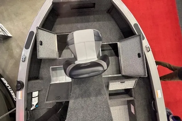 Slide: The Image of 2026 Crestliner 1850 Pro Tiller boat interior with storage compartments and seating. - 10