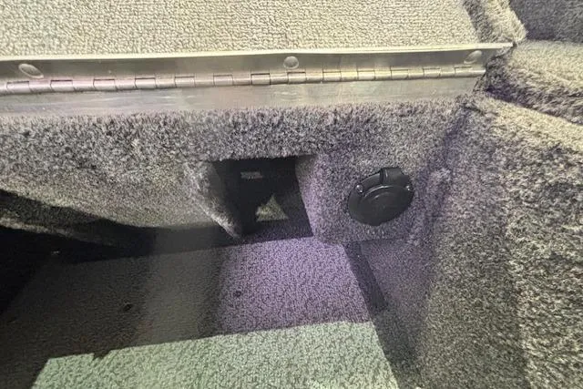 Slide: The Image of Interior view of 2026 Crestliner 1850 Pro Tiller boat with carpeted surfaces. - 12