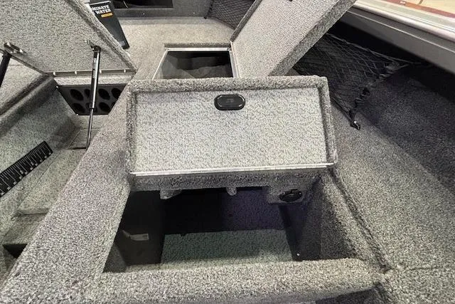 Slide: The Image of 2026 Crestliner 1850 Pro Tiller boat interior with open storage compartments. - 13