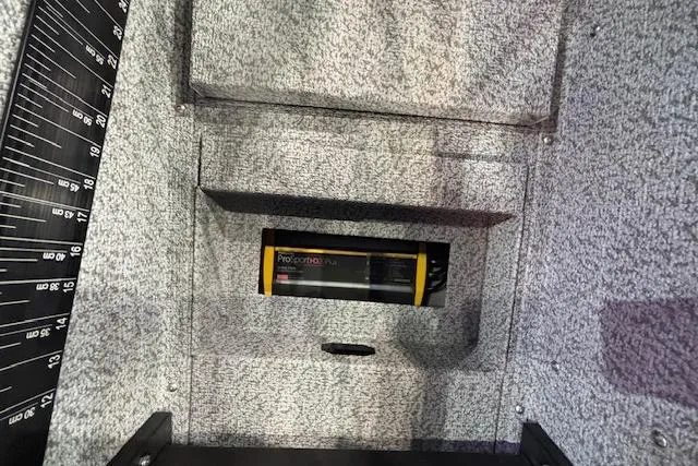 Slide: The Image of Interior of 2026 Crestliner 1850 Pro Tiller boat with storage compartment. - 14