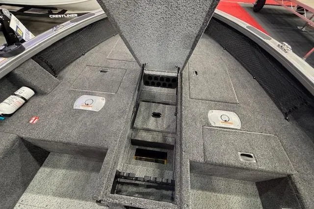 Slide: The Image of 2026 Crestliner 1850 Pro Tiller boat interior with open storage compartments and carpeted flooring. - 15