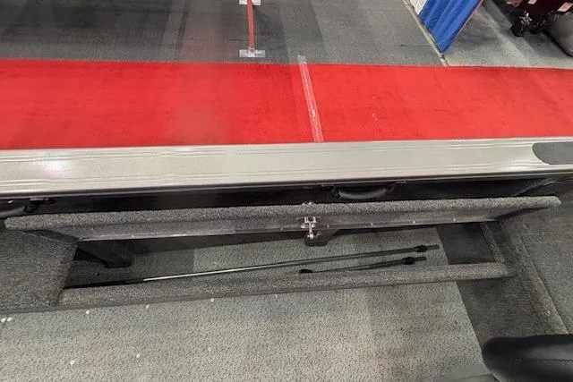 Slide: The Image of 2026 Crestliner 1850 Pro Tiller boat interior with red and gray carpeted flooring. - 17