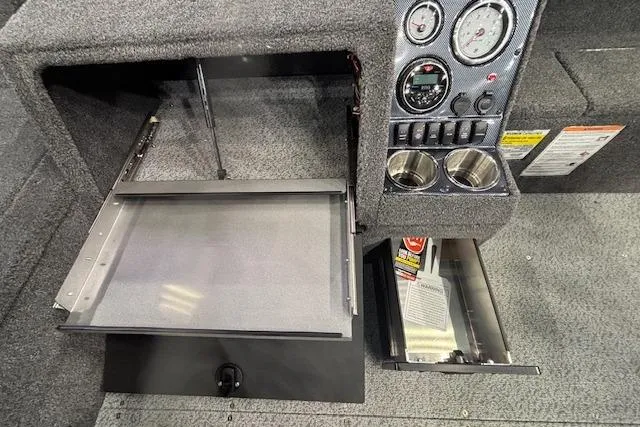 Slide: The Image of 2026 Crestliner 1850 Pro Tiller dashboard with storage compartments and control panel. - 20