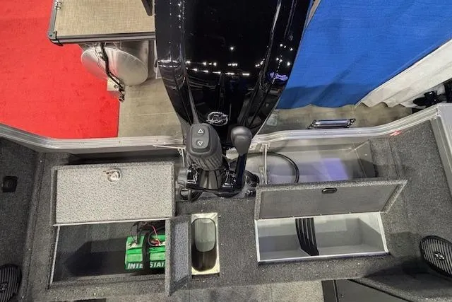 Slide: The Image of 2026 Crestliner 1850 Pro Tiller boat interior with storage compartments and motor controls. - 4