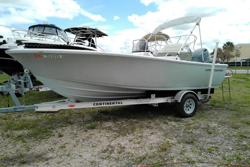 The Image of 2018 Sportsman Island Reef 19 Center Console boat on trailer, parked outdoors. - 1