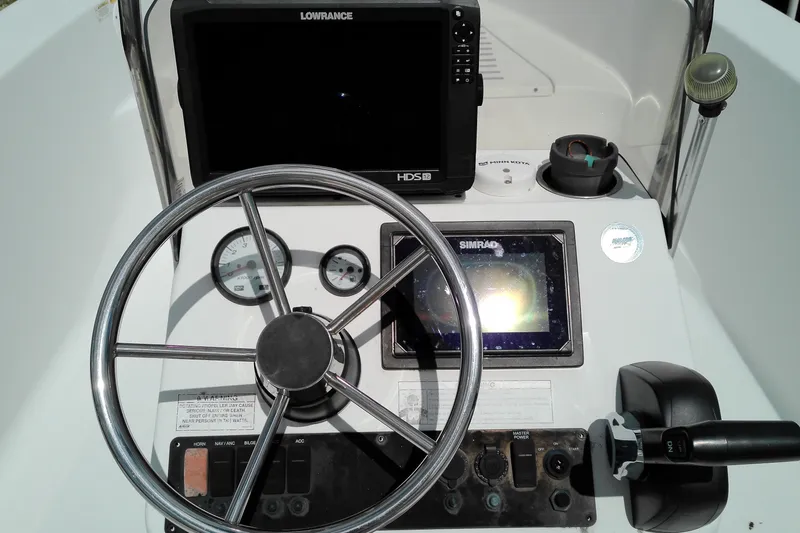 Slide: The Image of 2018 Sportsman Island Reef 19 Center Console dashboard with steering wheel and navigation equipment. - 5