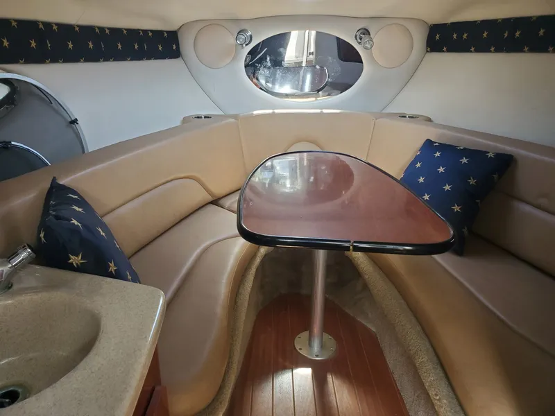 Slide: The Image of Interior of 2013 Crownline 264 CR with table and seating area. - 10