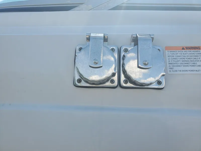 Slide: The Image of Crownline 264 CR 2013 boat power outlets with warning label. - 15
