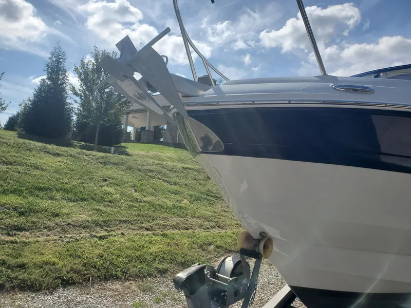 Slide: The Image of 2013 Crownline 264 CR boat on trailer in sunny weather. - 2