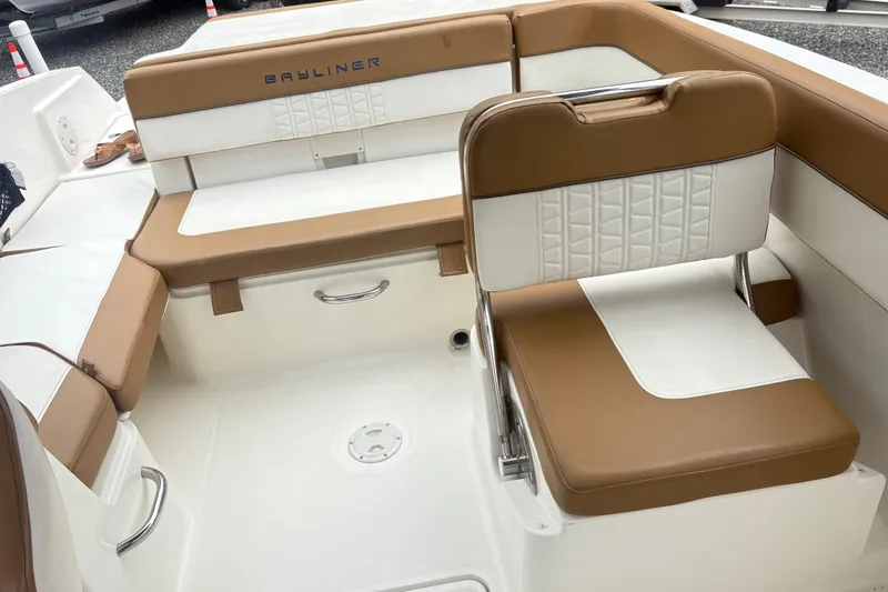 Slide: The Image of 2022 Bayliner VR6 Bowrider OB interior with tan and white seating. - 10