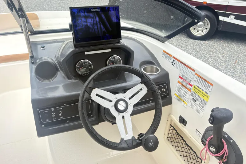 Slide: The Image of Steering console of 2022 Bayliner VR6 Bowrider OB with Simrad display and controls. - 12