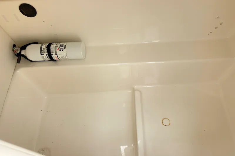 Slide: The Image of 2022 Bayliner VR6 Bowrider OB interior with mounted fire extinguisher. - 14