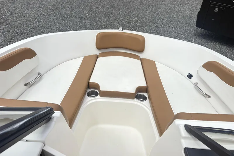 Slide: The Image of 2022 Bayliner VR6 Bowrider OB interior with tan and white seating, cup holders, and sleek design. - 15