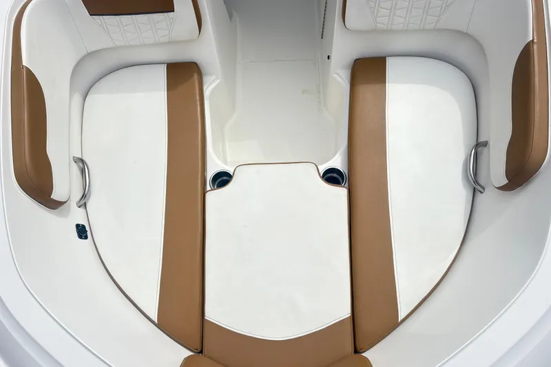 Slide: The Image of 2022 Bayliner VR6 Bowrider OB interior with brown and white cushioned seating. - 16