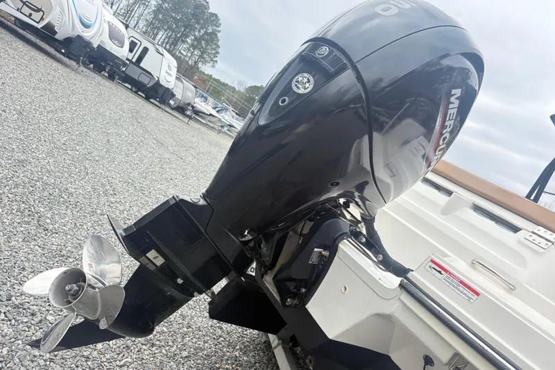 Slide: The Image of 2022 Bayliner VR6 Bowrider OB with Mercury outboard motor in a gravel lot. - 6