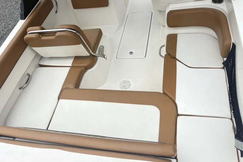 Slide: The Image of 2022 Bayliner VR6 Bowrider OB interior with tan and white seating arrangement. - 9