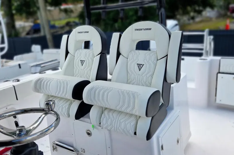 Slide: The Image of Luxury seating on 2026 Twin Vee 280 GFX2 CC boat, featuring sleek white upholstery. - 12