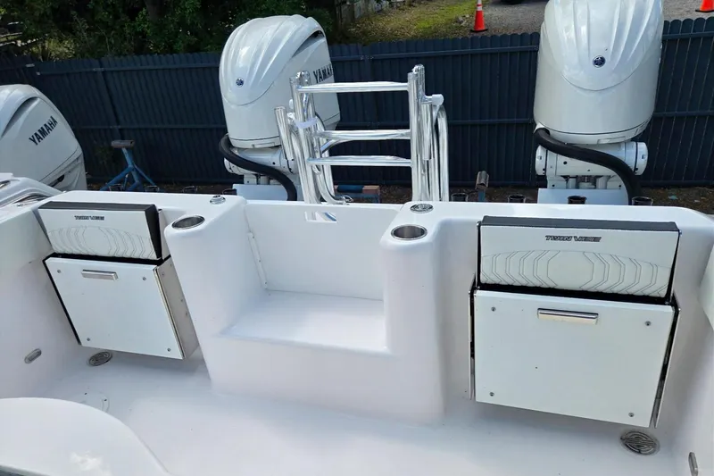 Slide: The Image of 2026 Twin Vee 280 GFX2 CC boat with Yamaha engines and storage compartments. - 13