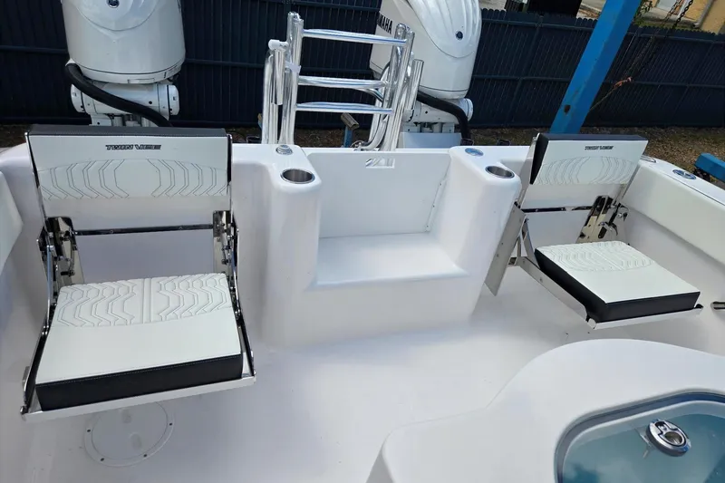 Slide: The Image of 2026 Twin Vee 280 GFX2 CC boat interior with foldable seating and dual outboard motors. - 15