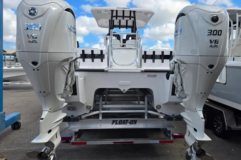 Slide: The Image of 2026 Twin Vee 280 GFX2 CC boat with dual Yamaha 300 V6 engines on trailer. - 2