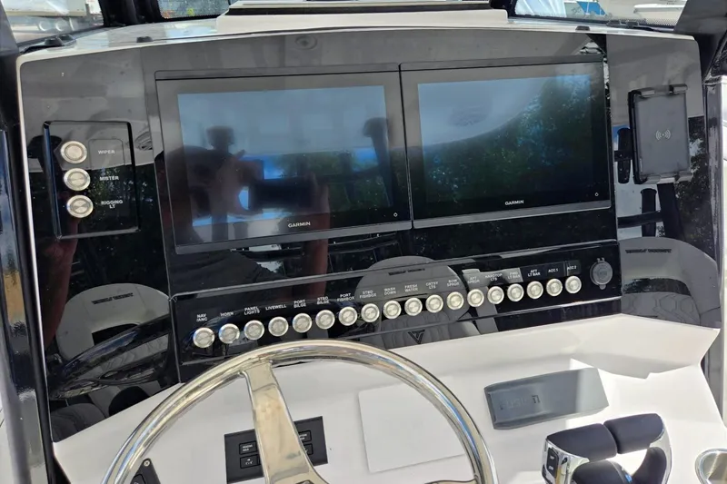 Slide: The Image of 2026 Twin Vee 280 GFX2 CC boat dashboard with dual Garmin displays and control panel. - 20
