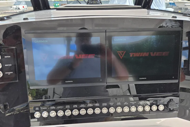 Slide: The Image of 2026 Twin Vee 280 GFX2 CC dashboard with dual Garmin displays and control panel. - 25