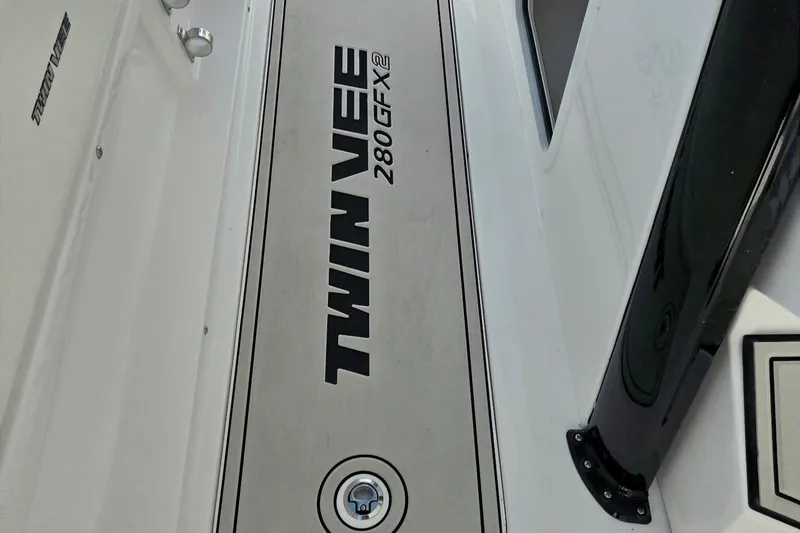 Slide: The Image of 2026 Twin Vee 280 GFX2 CC boat deck with logo and sleek design. - 26