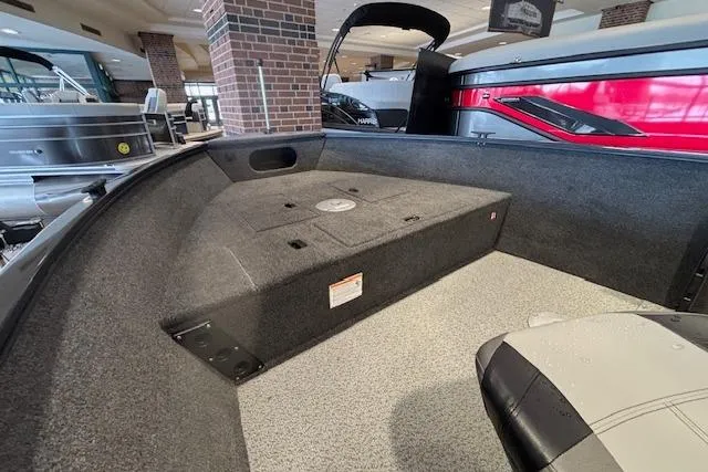 Slide: The Image of 2026 Crestliner 1650 Kodiak Tiller interior with carpeted deck and seating in showroom. - 10