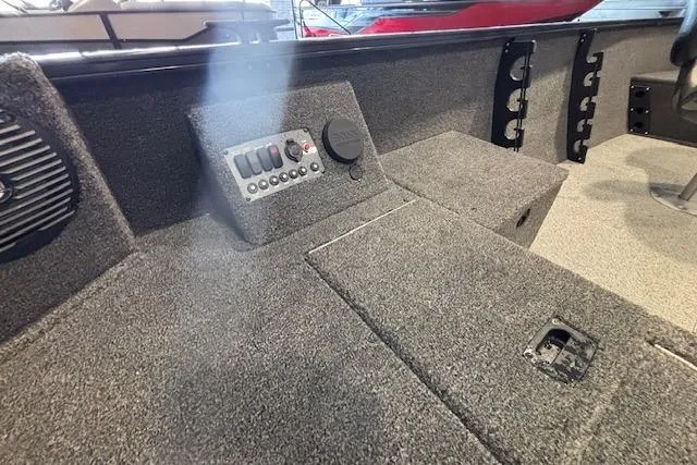 Slide: The Image of Interior of 2026 Crestliner 1650 Kodiak Tiller boat with control panel and seating. - 13