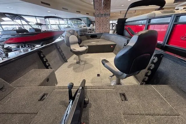 Slide: The Image of 2026 Crestliner 1650 Kodiak Tiller boat interior with seating and storage compartments. - 14