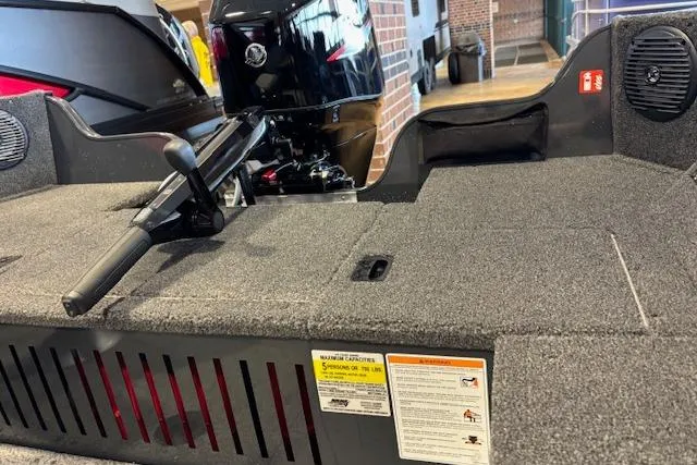 Slide: The Image of 2026 Crestliner 1650 Kodiak Tiller boat interior with motor and control handle. - 3