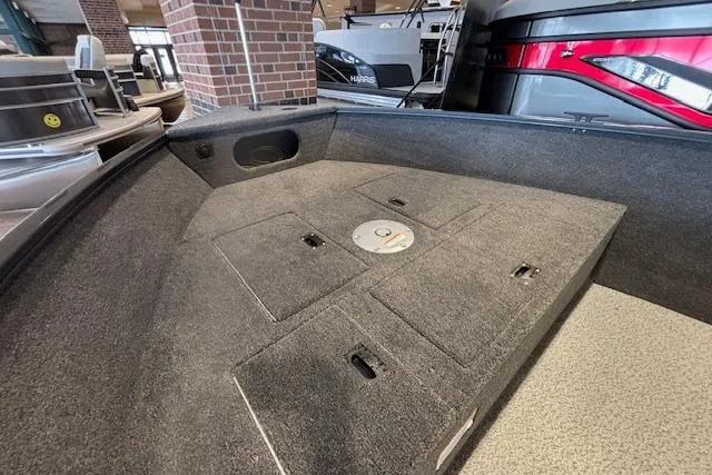 Slide: The Image of 2026 Crestliner 1650 Kodiak Tiller boat interior with carpeted storage compartments. - 9