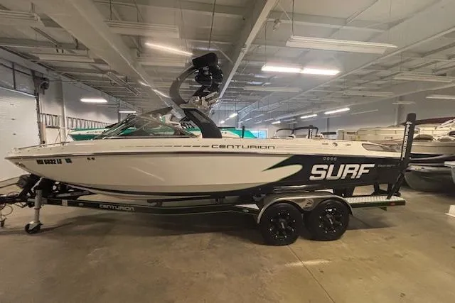 The Image of 2012 Centurion Enzo SV244 boat in indoor storage, featuring "Surf" branding. - 1