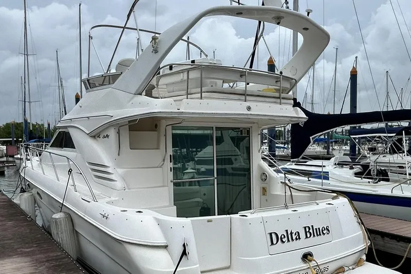 The Image of 1999 Sea Ray 400 Sedan Bridge yacht docked at marina, named "Delta Blues." - 0