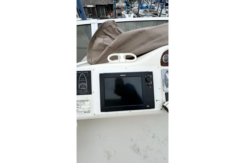 Slide: The Image of 1999 Sea Ray 400 Sedan Bridge helm with navigation display and controls. - 18