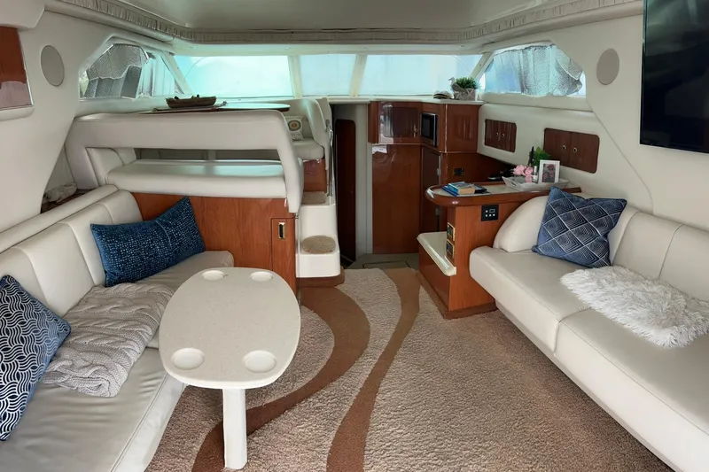 Slide: The Image of Luxurious interior of a 1999 Sea Ray 400 Sedan Bridge yacht with plush seating and elegant decor. - 24