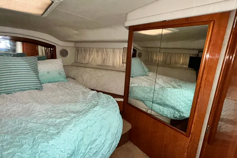 Slide: The Image of Interior cabin of 1999 Sea Ray 400 Sedan Bridge with bed and mirrored closet. - 34