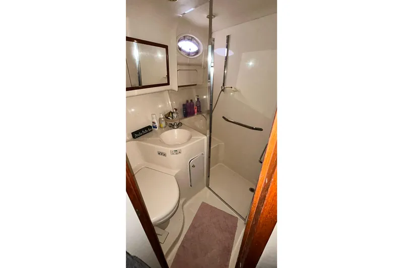 Slide: The Image of Bathroom interior of 1999 Sea Ray 400 Sedan Bridge yacht, featuring shower and sink. - 35