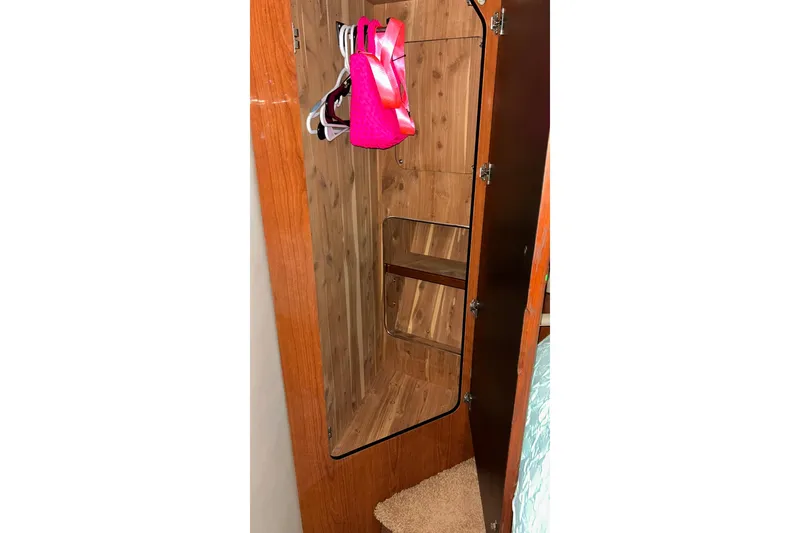 Slide: The Image of Wooden closet interior on a 1999 Sea Ray 400 Sedan Bridge yacht. - 36