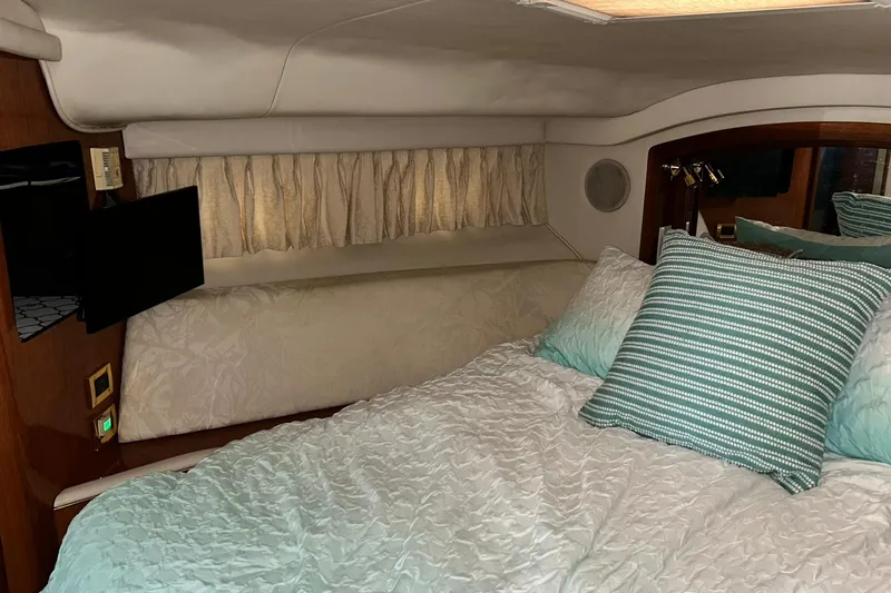 Slide: The Image of Cozy bedroom interior of 1999 Sea Ray 400 Sedan Bridge yacht with striped pillows. - 37