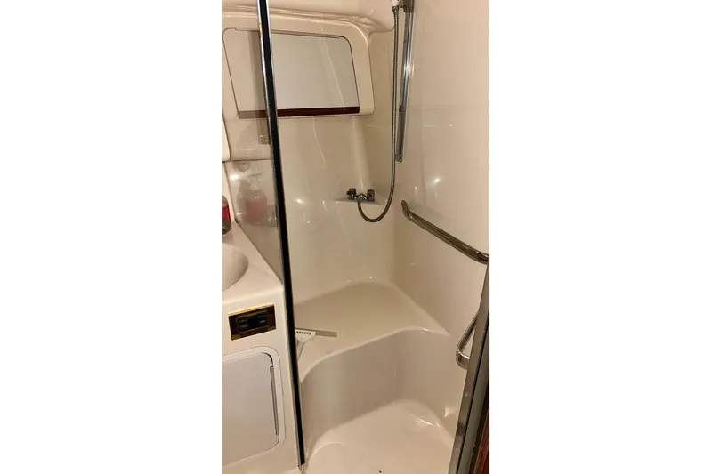Slide: The Image of 1999 Sea Ray 400 Sedan Bridge bathroom with shower, featuring sleek design and modern fixtures. - 39